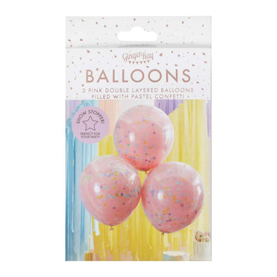 Rosa og pastellfargede ballonger med regnbuekonfetti